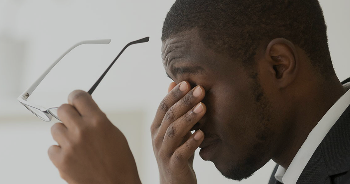 Man rubbing his eyes.