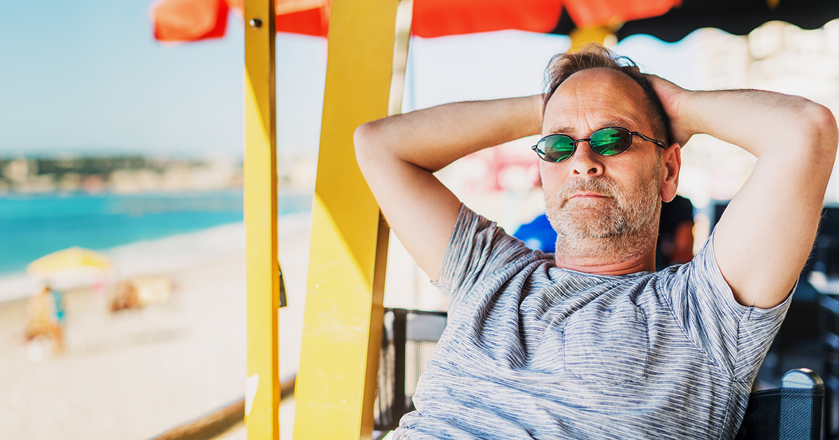 Man with sunglasses on beach.