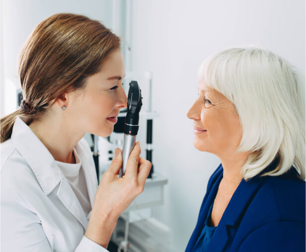 doctor checking senior eyes at VisionQuest Eyecare