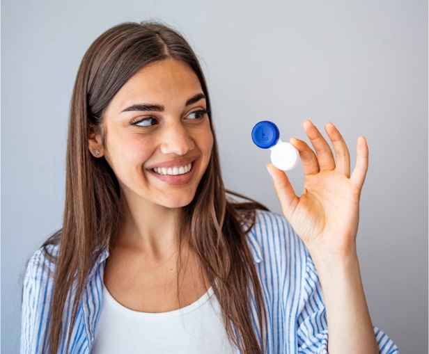 woman holding a contact lens at VisionQuest Eyecare