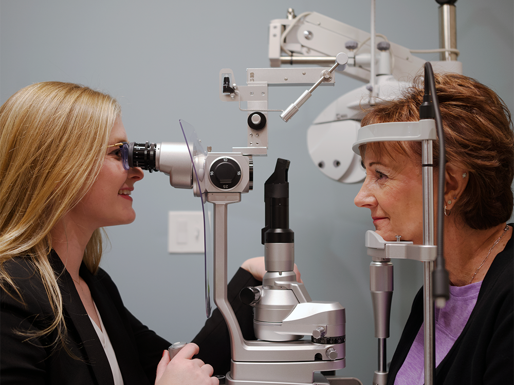 Age-Related Macular Degeneration l VisionQuest Eyecare Eye doctor examining woman