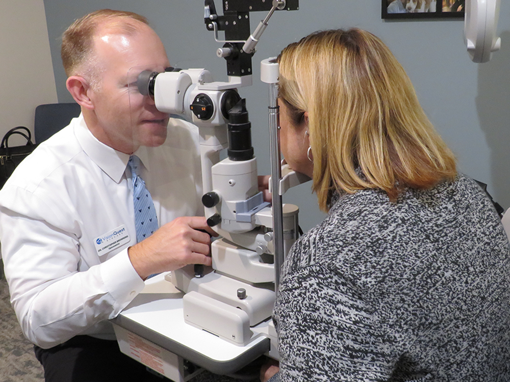 Eye doctor examining woman patient.