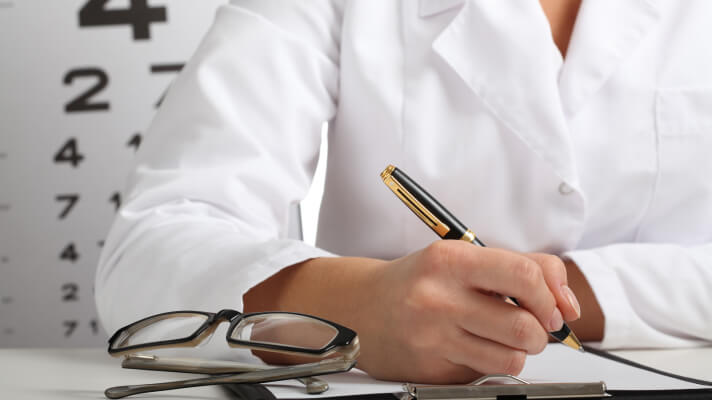 doctor writing a result diagnose at VisionQuest Eyecare